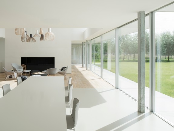 Dining table in a modern living room with a large window front	