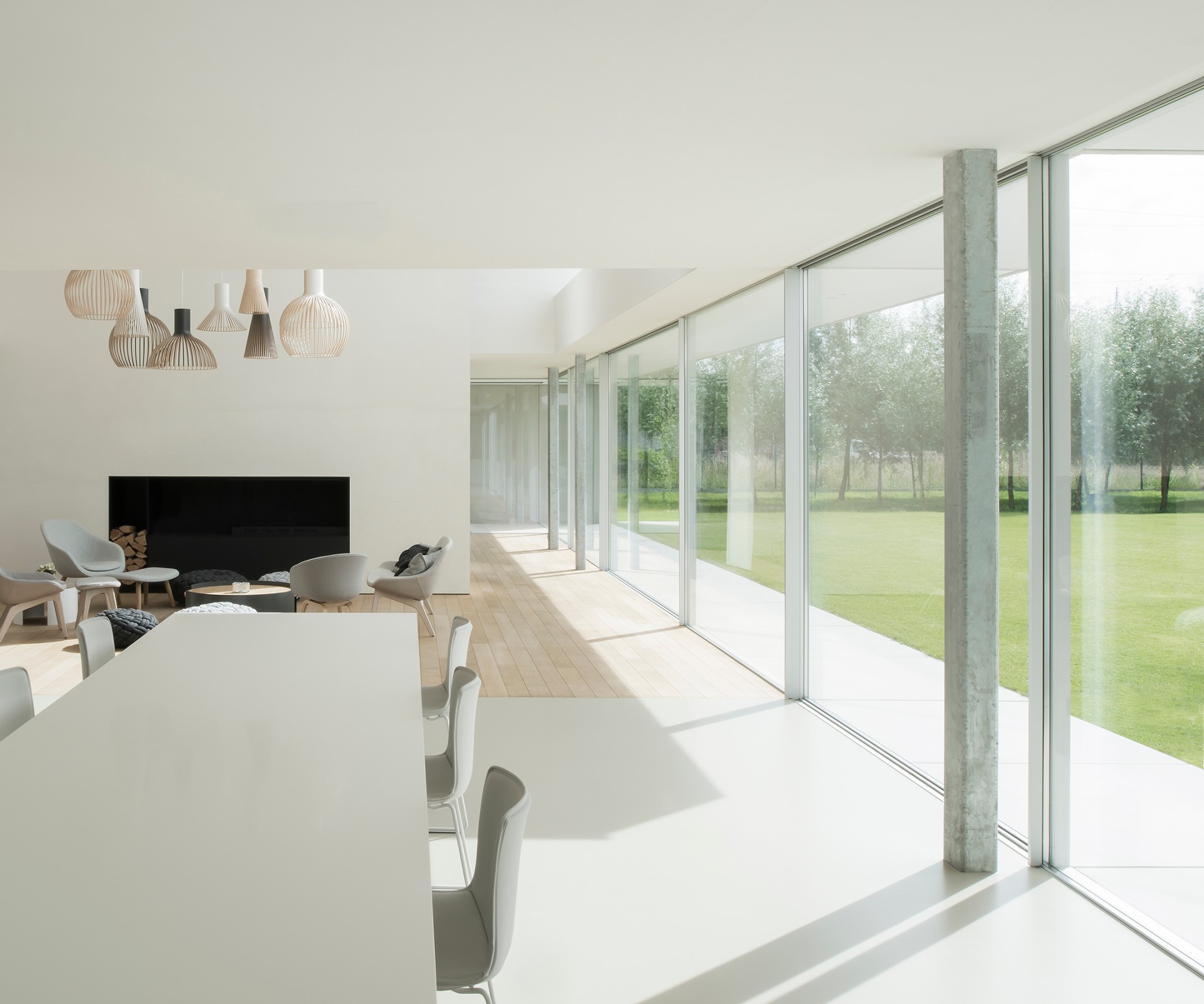 Dining table in a modern living room with a large window front	